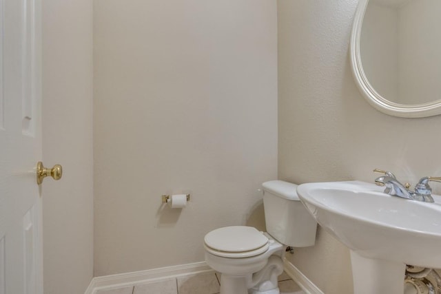 bathroom featuring tile patterned floors, toilet, and sink