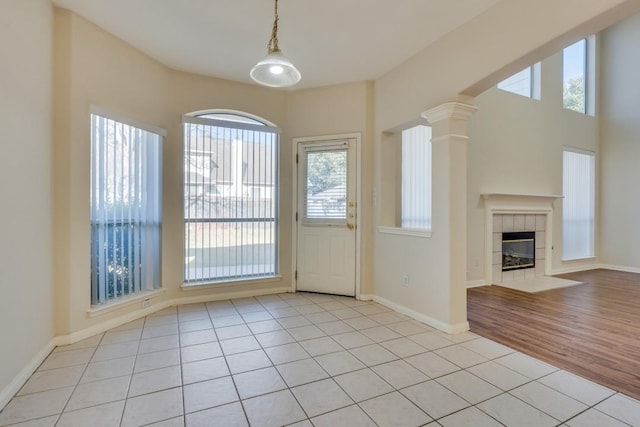 doorway to outside featuring a fireplace and light hardwood / wood-style flooring