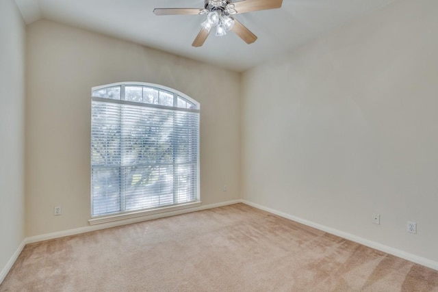 unfurnished room featuring ceiling fan, light colored carpet, and lofted ceiling