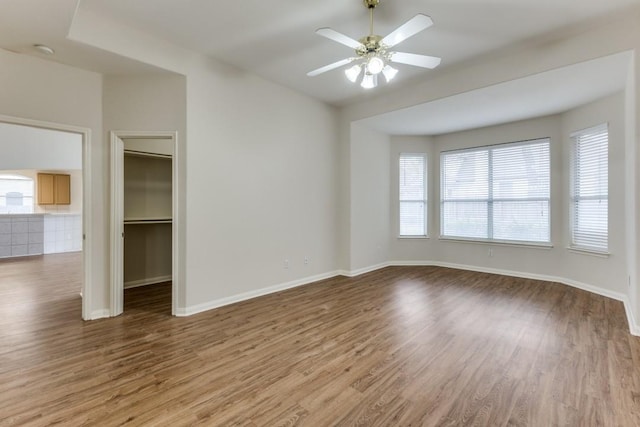 712 Runners Rdg, Pflugerville, TX 78660 - unfurnished room featuring wood finished floors, a ceiling fan, and a smoke detector