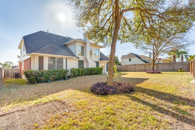 712 Runners Rdg, Pflugerville, TX 78660 - back of house with a fenced backyard, a chimney, a shingled roof, and brick siding