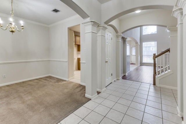 712 Runners Rdg, Pflugerville, TX 78660 - entrance foyer with ornamental molding, light tile patterned floors, light colored carpet, ornate columns, and arched walkways