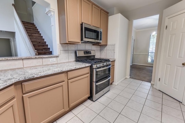 712 Runners Rdg, Pflugerville, TX 78660 - kitchen featuring backsplash, crown molding, appliances with stainless steel finishes, light tile patterned floors, and baseboards