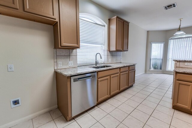 712 Runners Rdg, Pflugerville, TX 78660 - kitchen with stainless steel dishwasher, decorative backsplash, light tile patterned flooring, and light stone counters