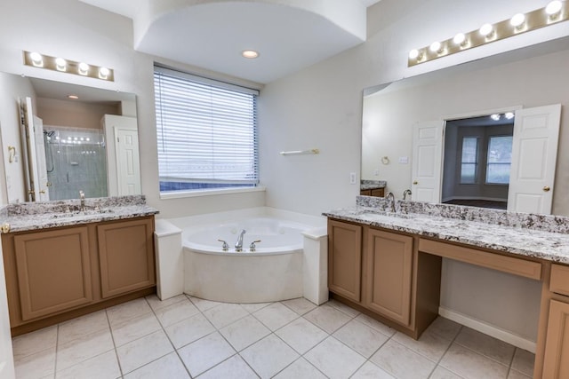 712 Runners Rdg, Pflugerville, TX 78660 - full bathroom with a stall shower, two vanities, a bath, and tile patterned floors