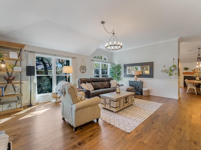 living room featuring a chandelier, light wood-type flooring, and a wealth of natural light