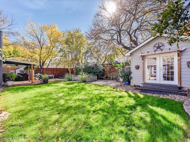 view of yard with a deck and french doors