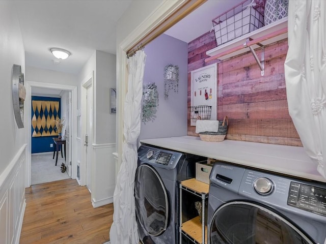 laundry room with light wood-type flooring and washing machine and dryer