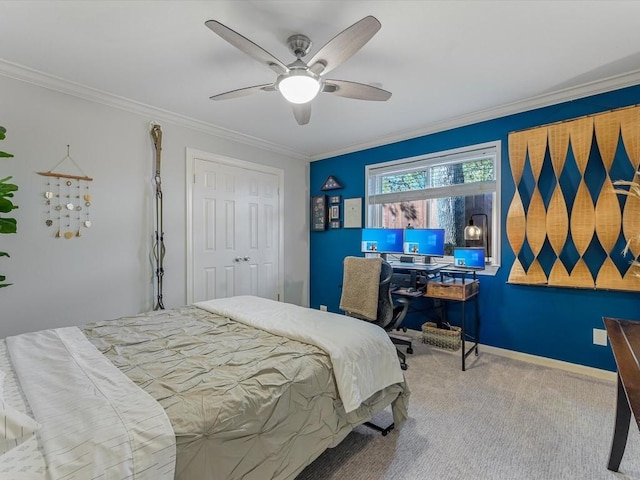 bedroom featuring ceiling fan, a closet, carpet, and crown molding