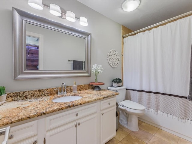 bathroom featuring toilet, vanity, tile patterned floors, and a shower with shower curtain