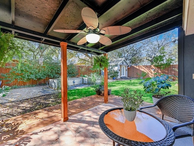 view of patio / terrace with ceiling fan and an outbuilding