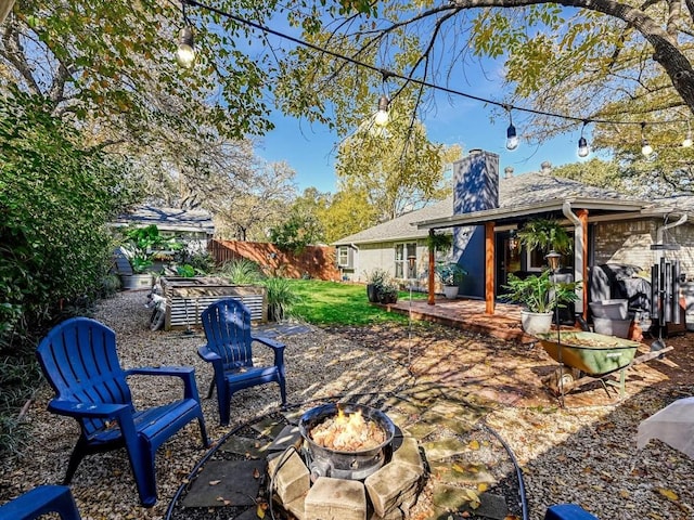 view of yard with an outdoor fire pit and a patio area