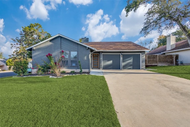 view of front of property featuring a front lawn and a garage