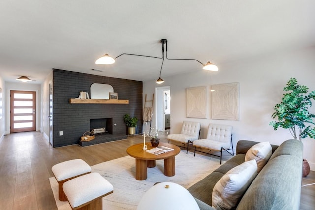 living room featuring a fireplace and light hardwood / wood-style flooring