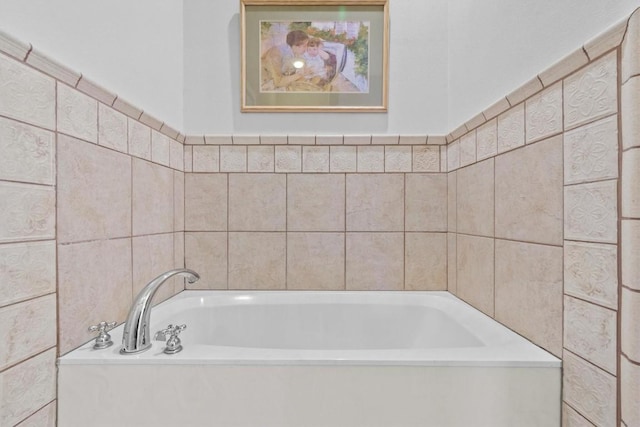 bathroom featuring a garden tub and tile walls