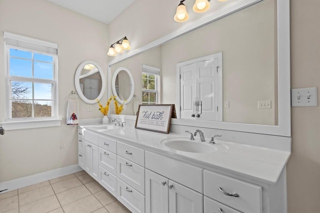 bathroom featuring double vanity, tile patterned flooring, baseboards, and a sink