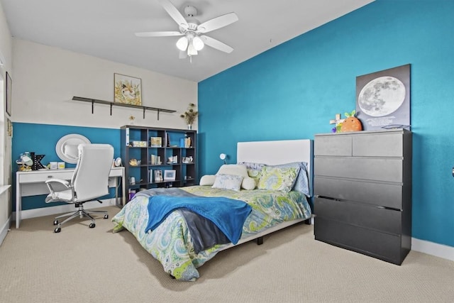 carpeted bedroom with a ceiling fan and baseboards