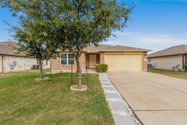 ranch-style home featuring a garage, a front lawn, and central air condition unit