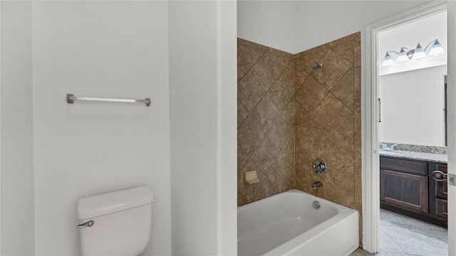 full bathroom featuring tile patterned flooring, tiled shower / bath combo, toilet, and vanity