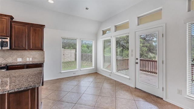 unfurnished sunroom with vaulted ceiling and a wealth of natural light