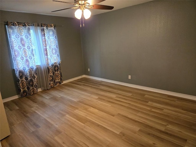 unfurnished room featuring hardwood / wood-style flooring and ceiling fan