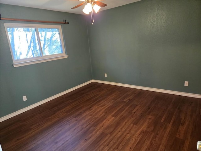 unfurnished room featuring ceiling fan and dark hardwood / wood-style floors