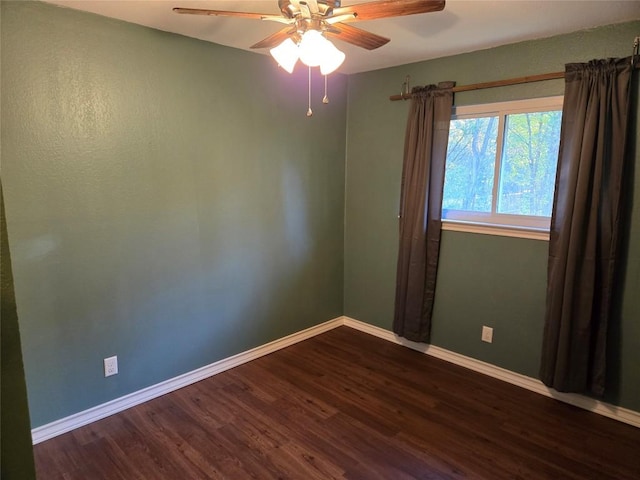 spare room featuring dark hardwood / wood-style flooring and ceiling fan