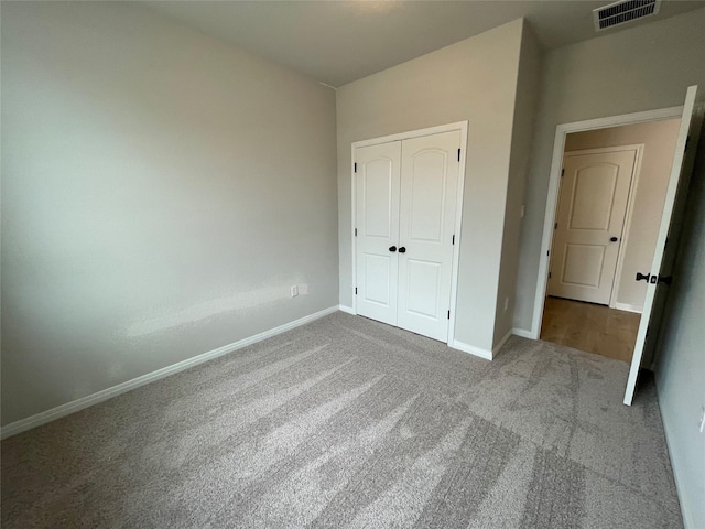 unfurnished bedroom with carpet and a closet