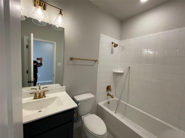 full bathroom with toilet, tiled shower / bath, and vanity