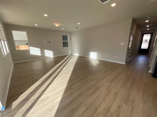 unfurnished living room featuring dark wood-type flooring