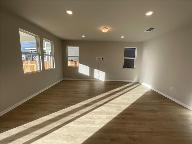 empty room with dark hardwood / wood-style flooring