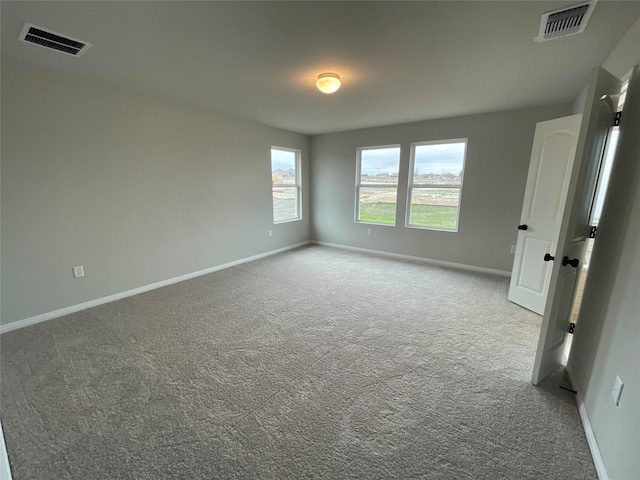 unfurnished room with light carpet