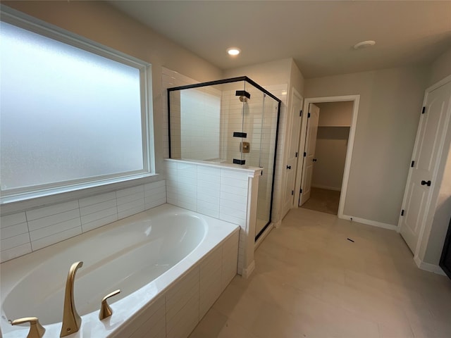 bathroom with tile patterned floors and separate shower and tub