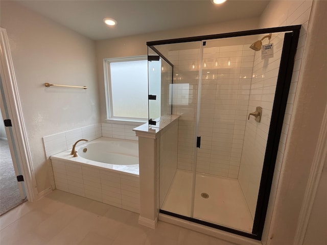 bathroom featuring tile patterned flooring and independent shower and bath