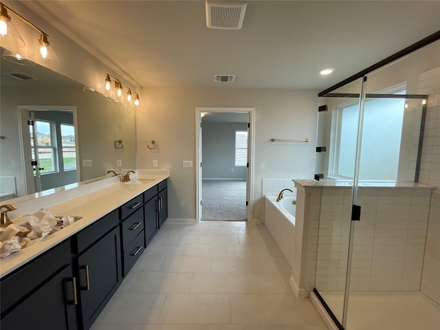 bathroom featuring vanity, independent shower and bath, and tile patterned flooring