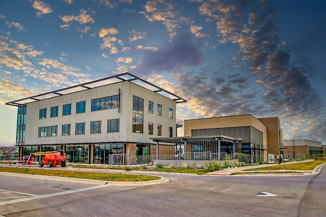 view of outdoor building at dusk