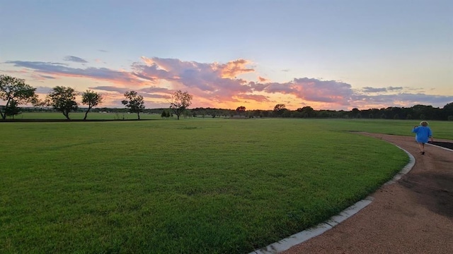 surrounding community featuring a lawn and a rural view