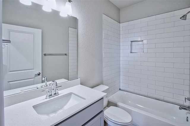 full bathroom with vanity, toilet, and tiled shower / bath combo