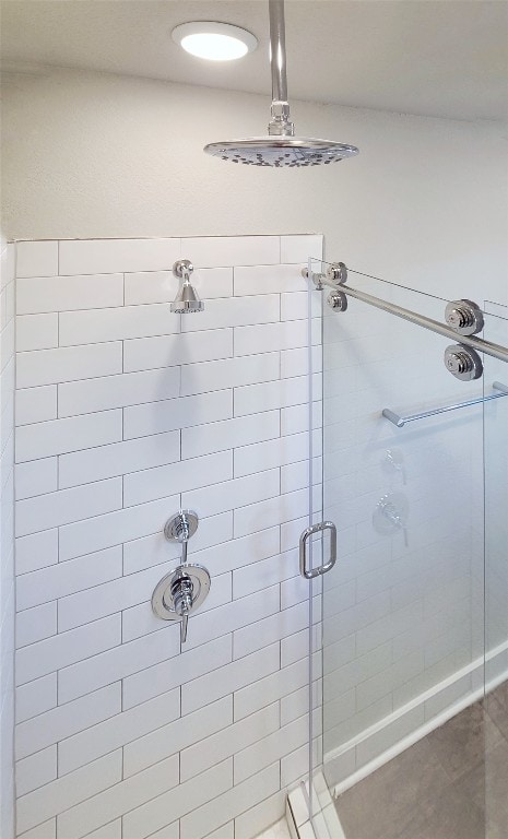 bathroom featuring a shower with shower door