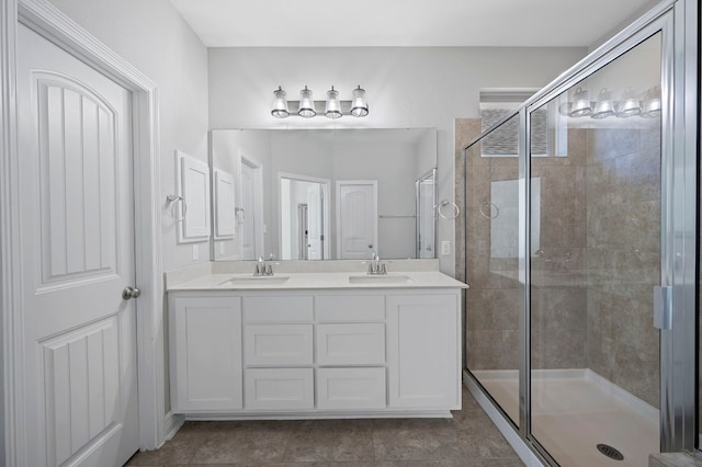 bathroom featuring tile patterned flooring, vanity, and walk in shower