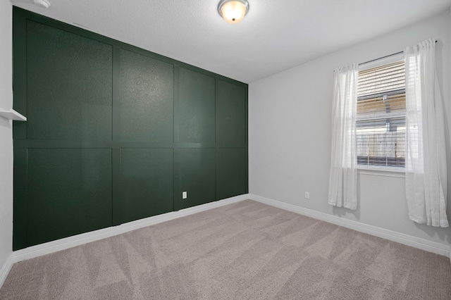 unfurnished room with light carpet