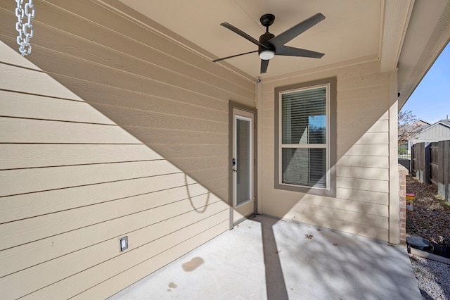 doorway to property with ceiling fan and a patio