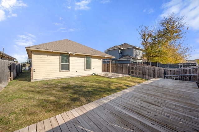 rear view of house featuring a fenced backyard, a yard, and a wooden deck