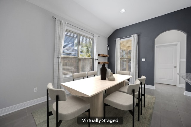 dining space featuring lofted ceiling, dark tile patterned flooring, recessed lighting, and baseboards