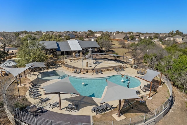 pool featuring a residential view, a patio area, and fence