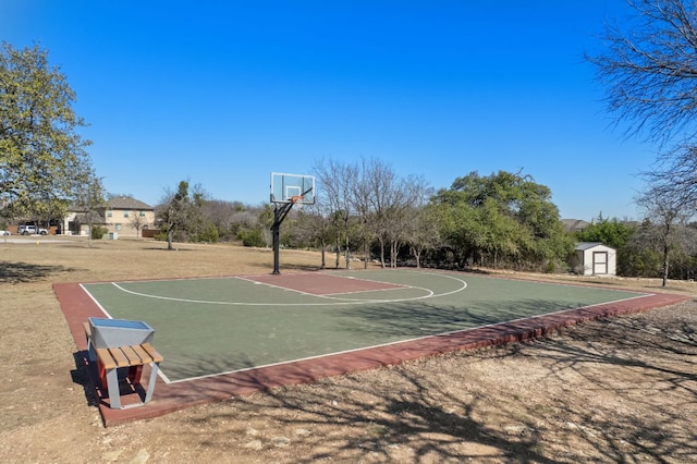 view of sport court with community basketball court and a storage unit