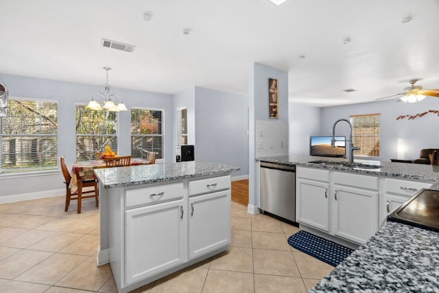 kitchen featuring a center island, dishwasher, sink, white cabinets, and ceiling fan with notable chandelier