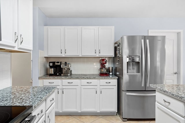 kitchen featuring white cabinetry, stainless steel fridge with ice dispenser, light stone counters, backsplash, and light tile patterned flooring