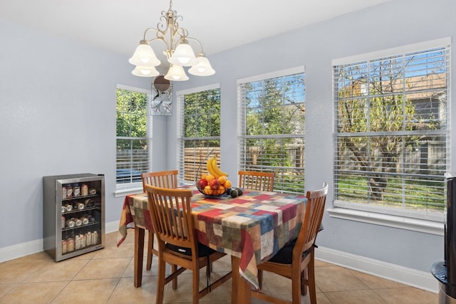 tiled dining area featuring wine cooler and a chandelier