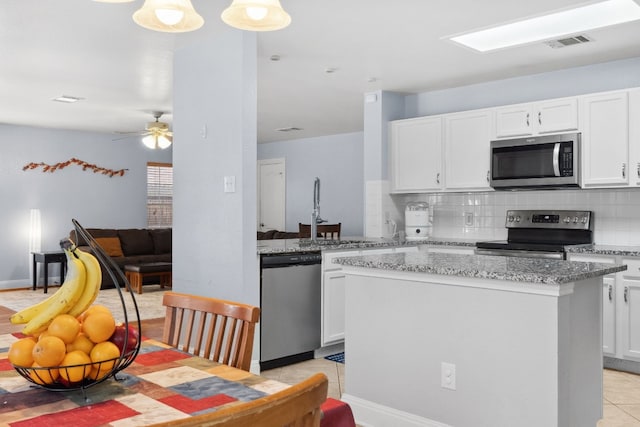 kitchen featuring a center island, white cabinetry, and appliances with stainless steel finishes